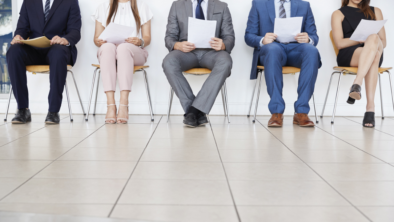 An image of 5 supply chain job candidates sit in a row as they wait for a Penta Search Blog article "How Supply Chain Expertise Yields Better Candidates"