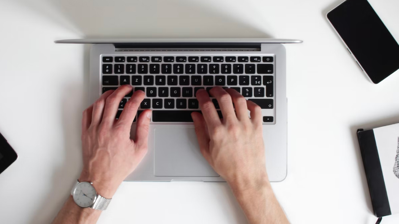 A birdseye view of a person begins a passive career search on their laptop.